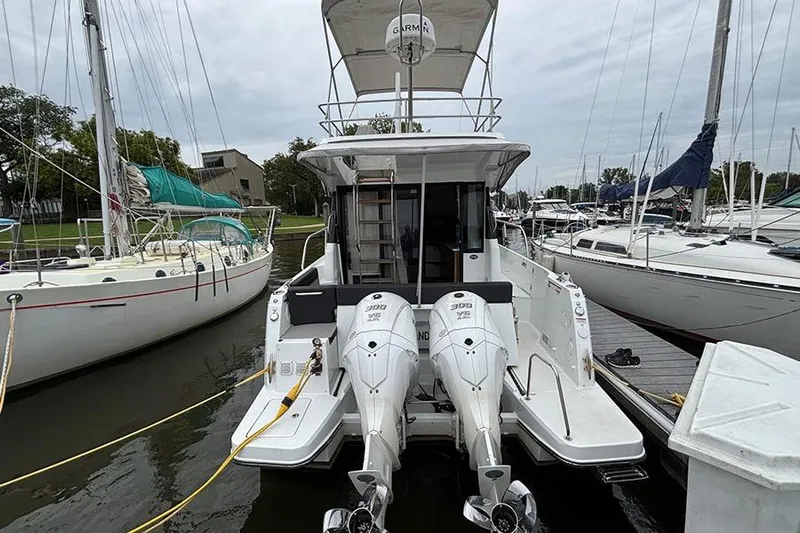  Yacht Photos Pics 2022 Jeanneau NC Weekender 1095 Fly docked with twin outboard engines.