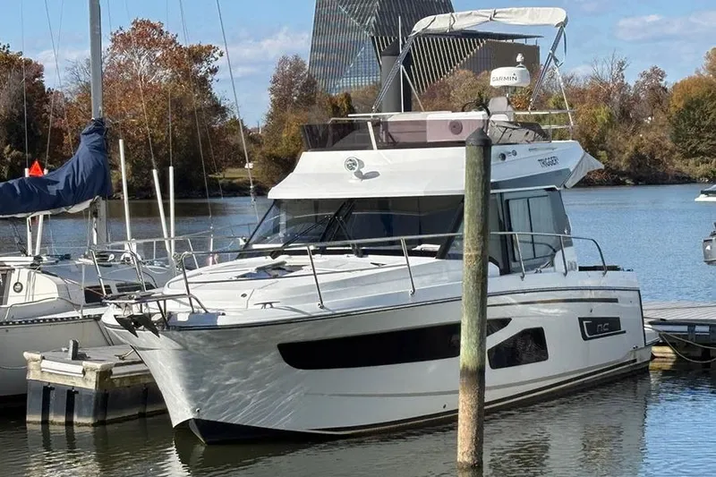  Yacht Photos Pics 2022 Jeanneau NC Weekender 1095 Fly moored at a scenic marina.