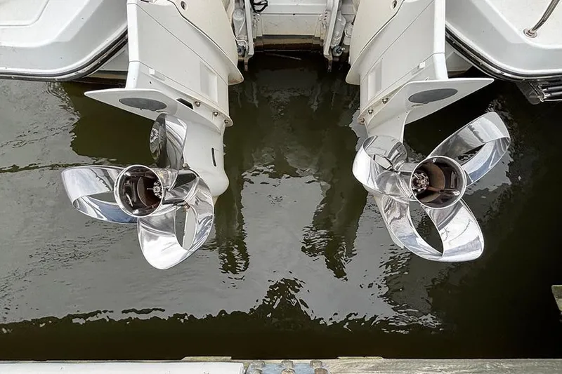  Yacht Photos Pics Twin propellers of a 2022 Jeanneau NC Weekender 1095 Fly boat in water.