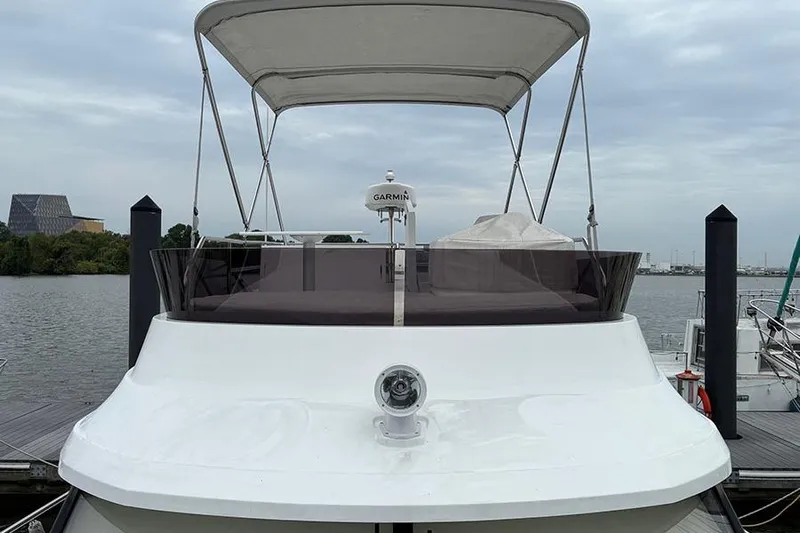  Yacht Photos Pics 2022 Jeanneau NC Weekender 1095 Fly yacht docked, featuring a Garmin radar and flybridge.