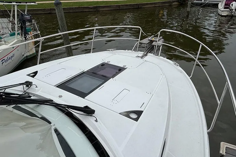  Yacht Photos Pics 2022 Jeanneau NC Weekender 1095 Fly boat docked, showcasing sleek deck design.