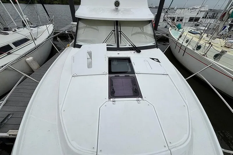  Yacht Photos Pics 2022 Jeanneau NC Weekender 1095 Fly docked, showcasing sleek deck design and modern features.