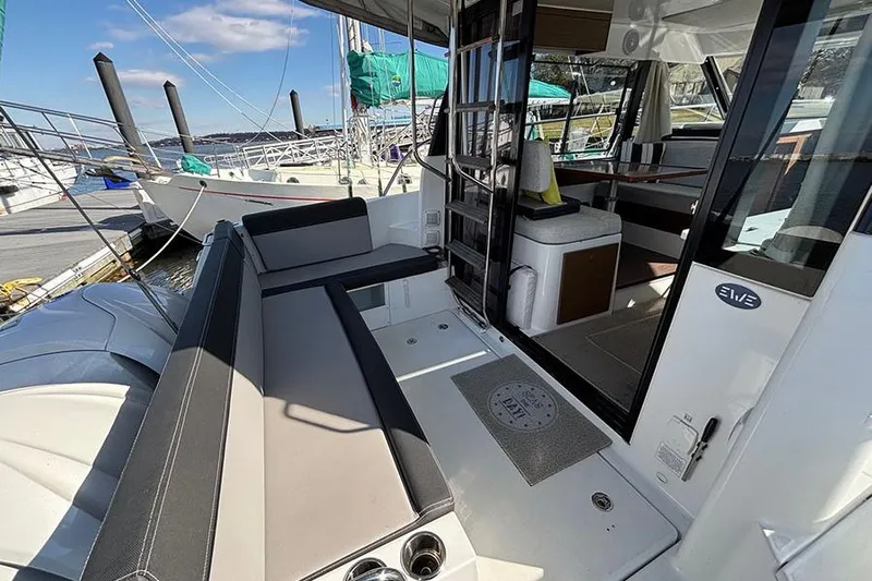  Yacht Photos Pics 2022 Jeanneau NC Weekender 1095 Fly, spacious deck with seating, docked at marina.