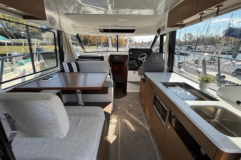  Yacht Photos Pics Interior of 2022 Jeanneau NC Weekender 1095 Fly, featuring modern kitchen and seating area.