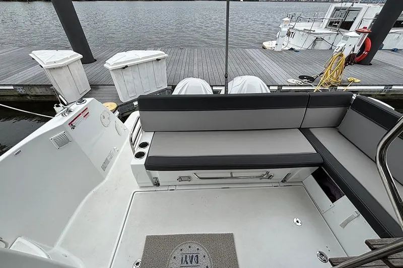  Yacht Photos Pics 2022 Jeanneau NC Weekender 1095 Fly boat interior with seating and dock view.