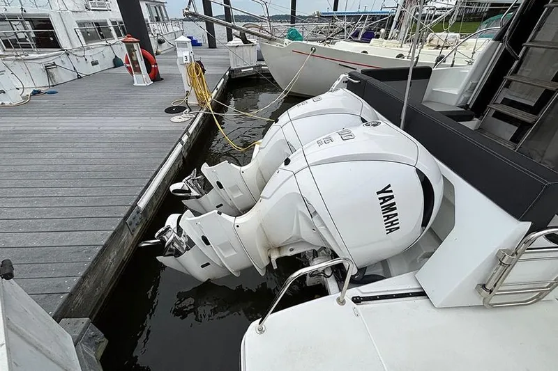  Yacht Photos Pics 2022 Jeanneau NC Weekender 1095 Fly with Yamaha outboard engines at dock.