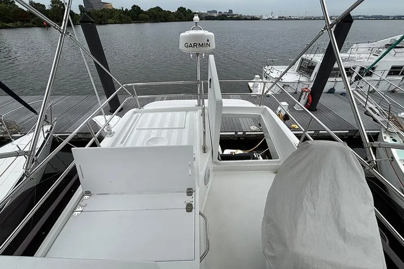  Yacht Photos Pics 2022 Jeanneau NC Weekender 1095 Flybridge, docked with Garmin equipment, overlooking serene water.