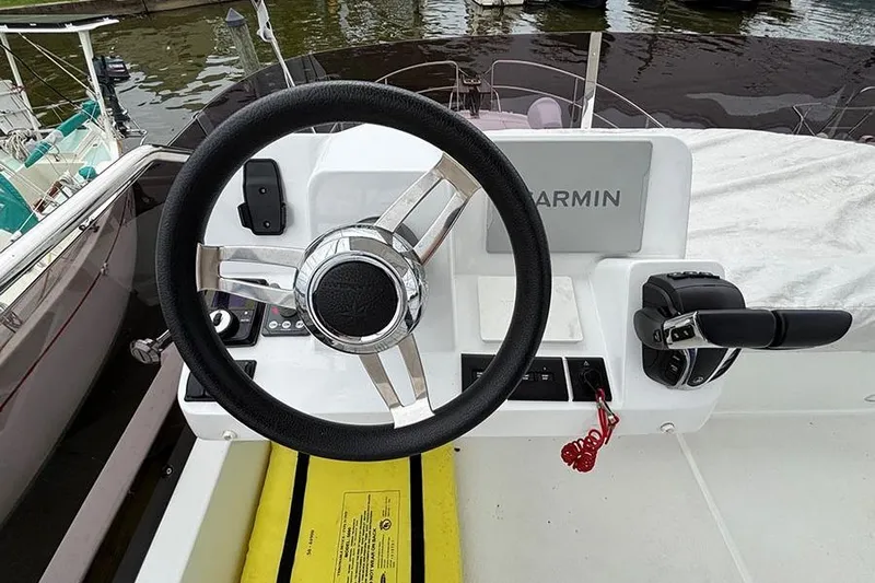  Yacht Photos Pics Steering wheel of 2022 Jeanneau NC Weekender 1095 Fly boat with Garmin navigation.