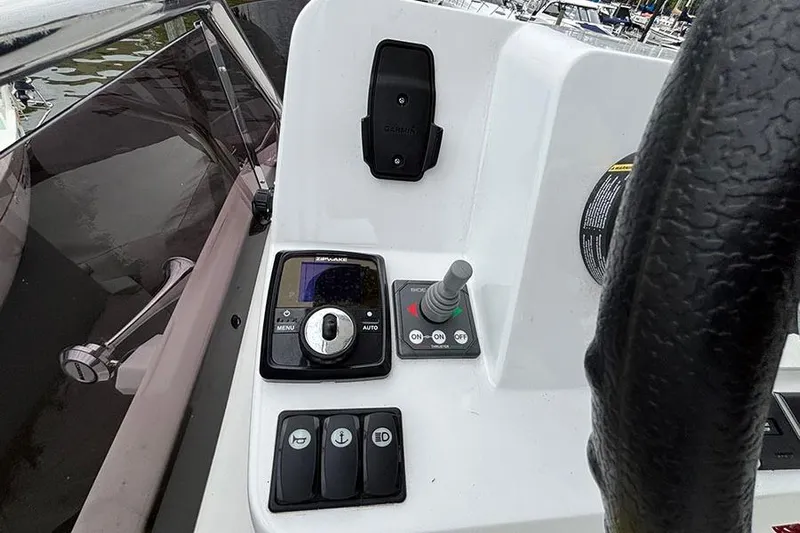  Yacht Photos Pics Control panel of 2022 Jeanneau NC Weekender 1095 Fly boat with steering wheel.