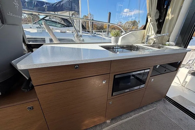  Yacht Photos Pics Modern kitchen area on 2022 Jeanneau NC Weekender 1095 Fly boat.