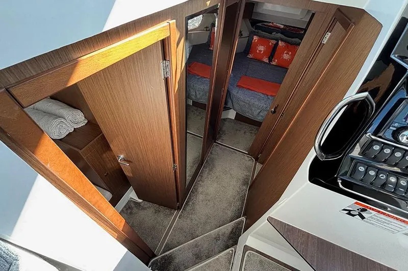  Yacht Photos Pics Interior of 2022 Jeanneau NC Weekender 1095 Fly, featuring cozy cabin and wooden finishes.