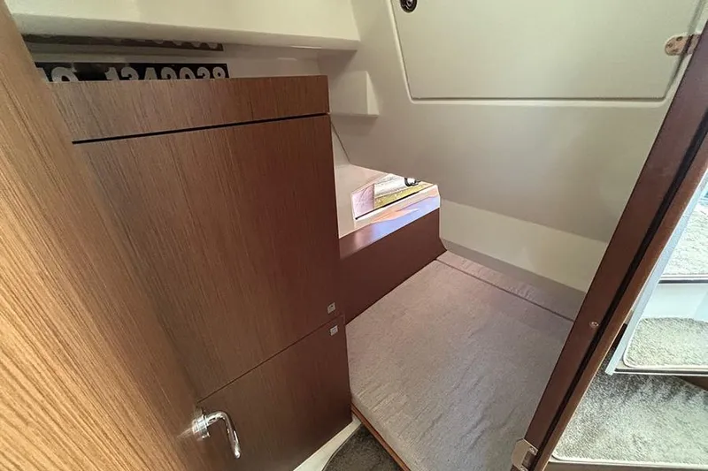  Yacht Photos Pics 2022 Jeanneau NC Weekender 1095 Fly cabin interior with wood finish and compact design.