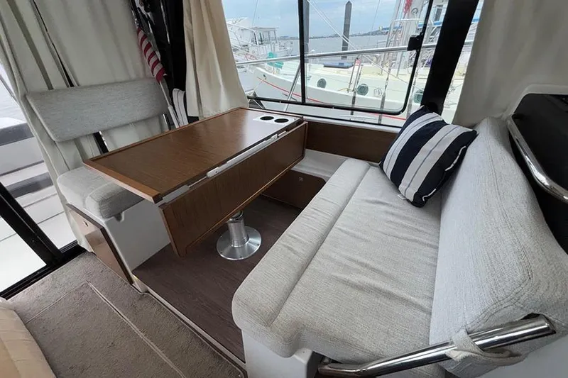  Yacht Photos Pics Interior of 2022 Jeanneau NC Weekender 1095 Fly with seating and table.