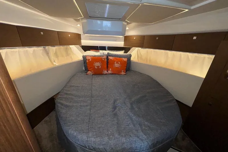  Yacht Photos Pics Luxurious cabin interior of 2022 Jeanneau NC Weekender 1095 Fly with cozy bedding.