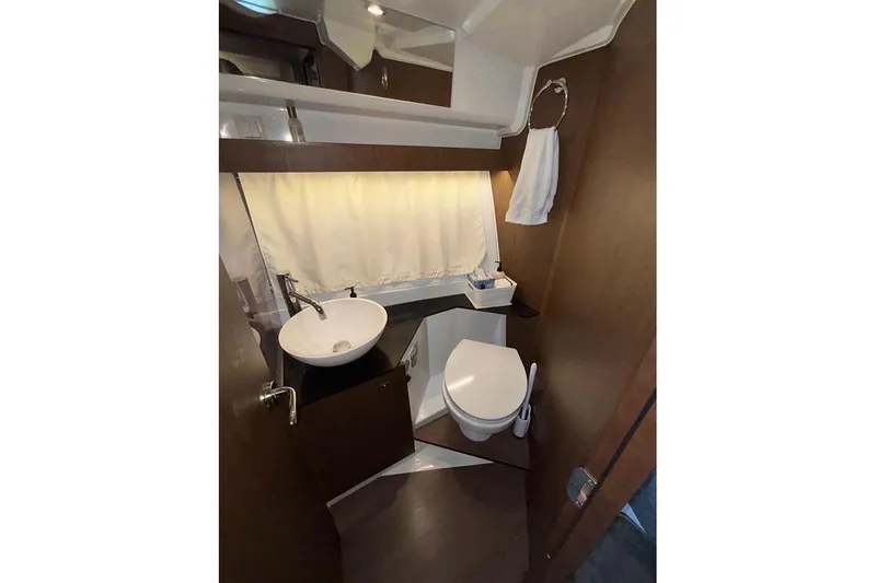  Yacht Photos Pics Bathroom interior of 2022 Jeanneau NC Weekender 1095 Fly, featuring sink and toilet.