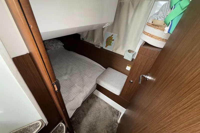  Yacht Photos Pics Cozy cabin interior of 2022 Jeanneau NC Weekender 1095 Fly with bed and storage.