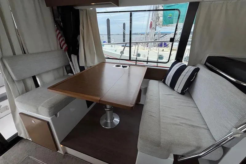  Yacht Photos Pics Interior of 2022 Jeanneau NC Weekender 1095 Fly with dining area and window view.