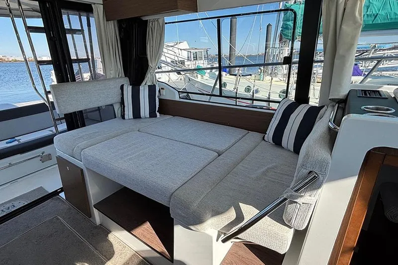  Yacht Photos Pics Interior of 2022 Jeanneau NC Weekender 1095 Fly with cozy seating and marina view.