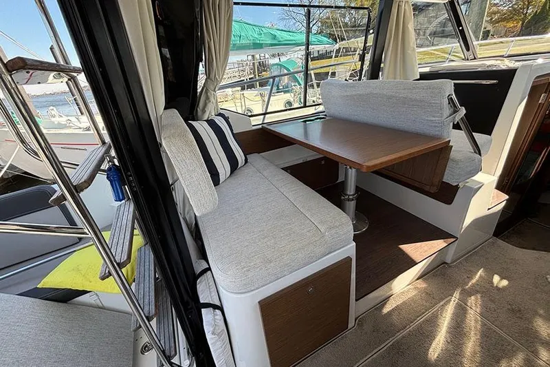  Yacht Photos Pics Interior of 2022 Jeanneau NC Weekender 1095 Fly with cozy seating and table.