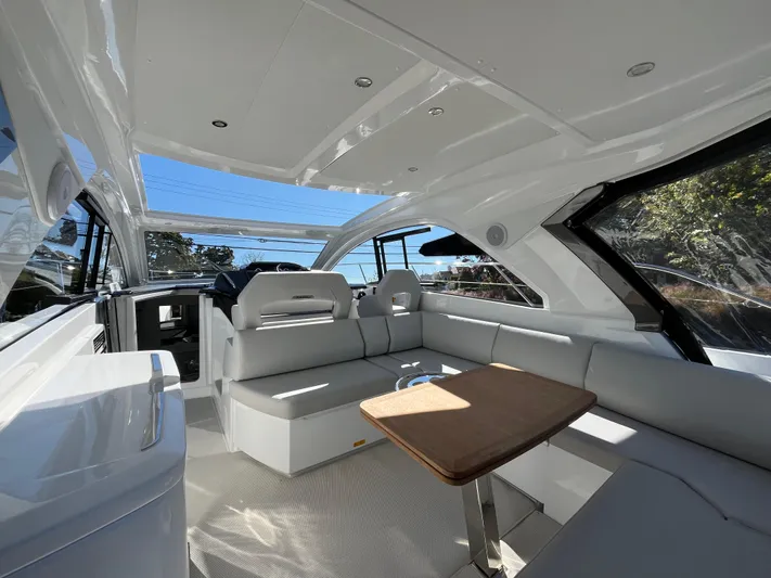  Yacht Photos Pics Luxurious interior of 2025 Beneteau Gran Turismo 41 yacht with sleek seating and table.