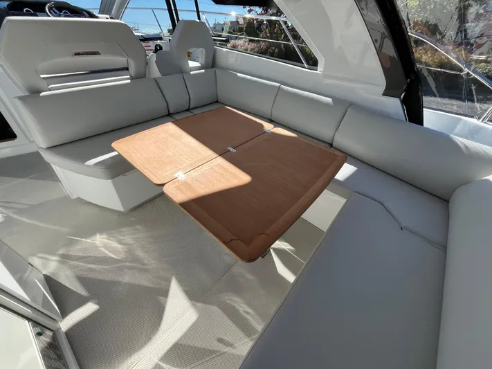  Yacht Photos Pics Luxurious interior of 2025 Beneteau Gran Turismo 41 yacht with elegant seating and wooden table.