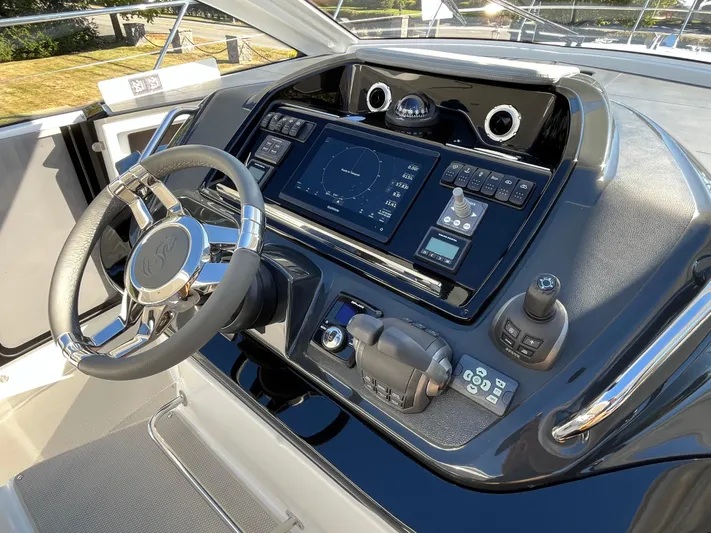  Yacht Photos Pics 2025 Beneteau Gran Turismo 41 helm with advanced navigation system and sleek steering wheel.