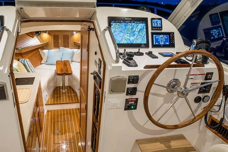 Tumalum Yacht Photos Pics Manufacturer Provided Image: 2023 MJM 35 boat interior with navigation system and cozy cabin.