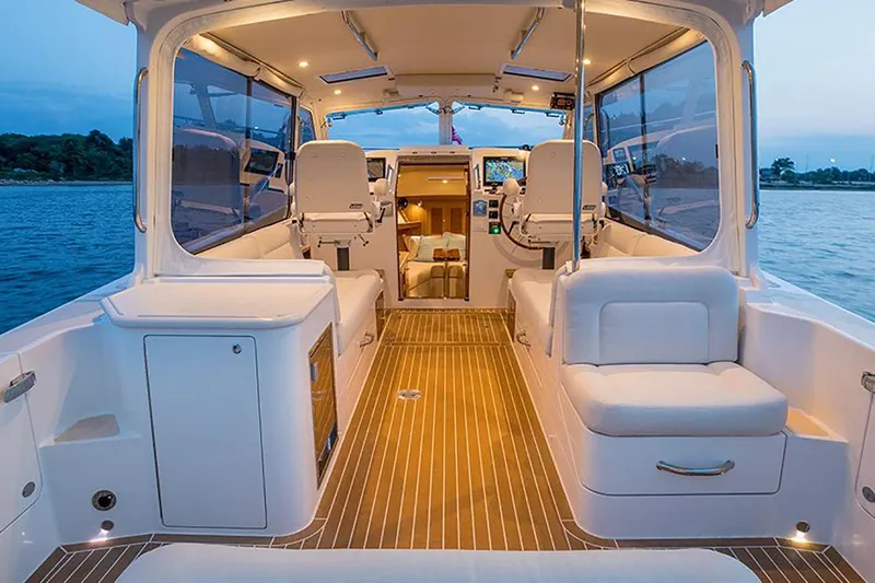 Tumalum Yacht Photos Pics Manufacturer Provided Image: Luxurious interior of 2023 MJM 35 boat with seating and navigation area.