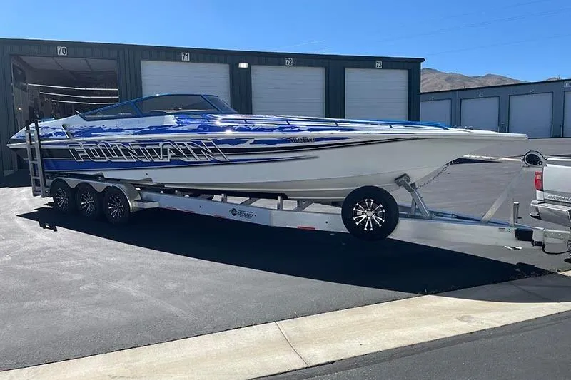 Wasted On You Yacht Photos Pics 2001 Fountain 35 Lightning boat on trailer, parked outside storage units.