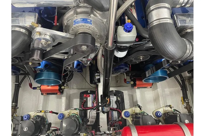 Wasted On You Yacht Photos Pics Engine compartment of a 2001 Fountain 35 Lightning boat, showcasing mechanical components and wiring.