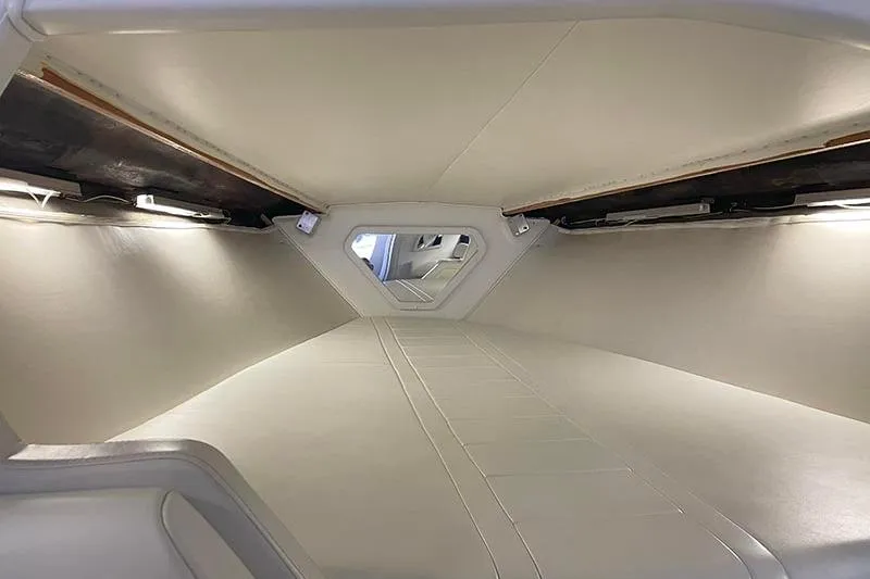 Wasted On You Yacht Photos Pics Interior cabin of a 2001 Fountain 35 Lightning boat, featuring sleek white design.