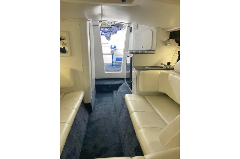 Wasted On You Yacht Photos Pics Interior of 2001 Fountain 35 Lightning boat with beige seating and compact kitchenette.