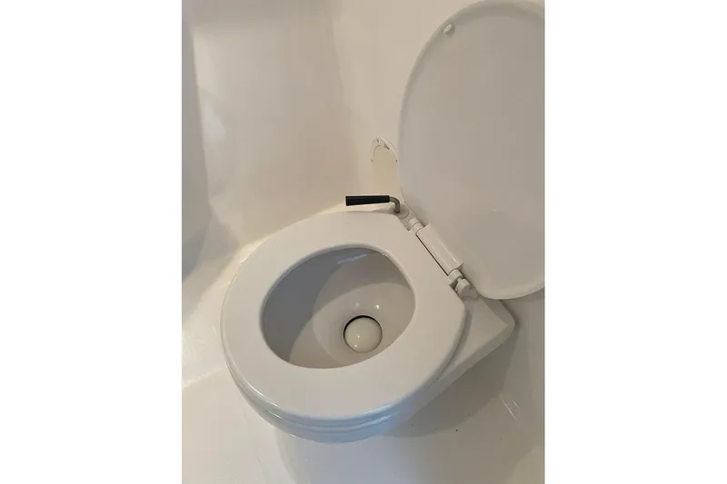 Wasted On You Yacht Photos Pics White toilet seat in a 2001 Fountain 35 Lightning boat bathroom.