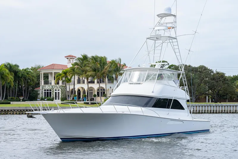  Yacht Photos Pics 2005 Viking 61 yacht cruising near waterfront mansion.