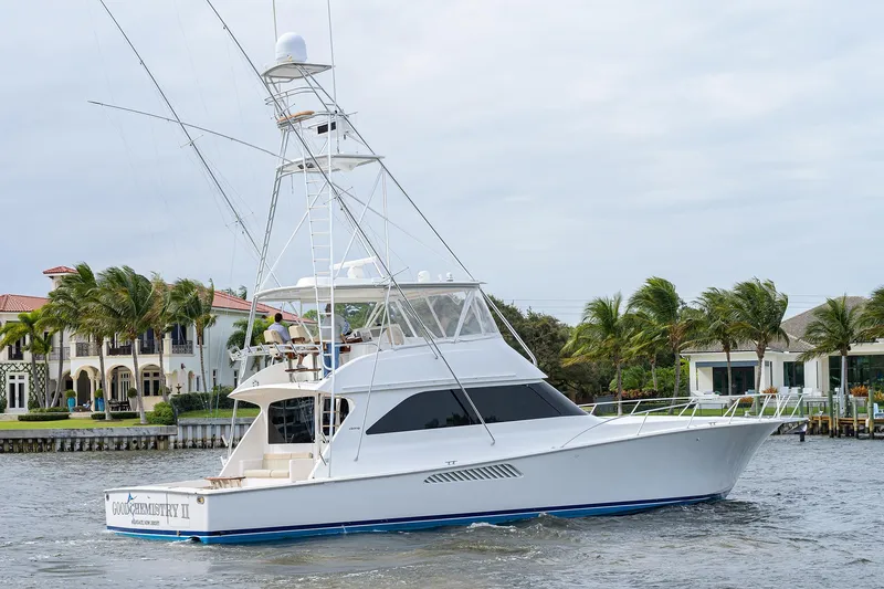 Yacht Photos Pics 2005 Viking 61 yacht cruising near waterfront homes with palm trees.
