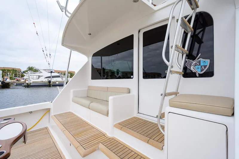  Yacht Photos Pics 2005 Viking 61 yacht deck with seating and ladder, docked at marina.