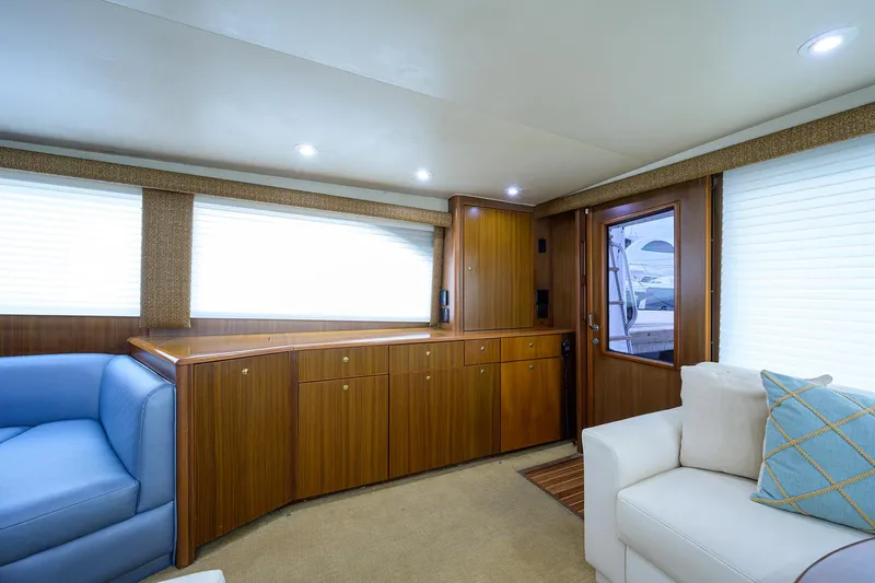  Yacht Photos Pics Luxurious interior of 2005 Viking 61 yacht with wood cabinetry and plush seating.