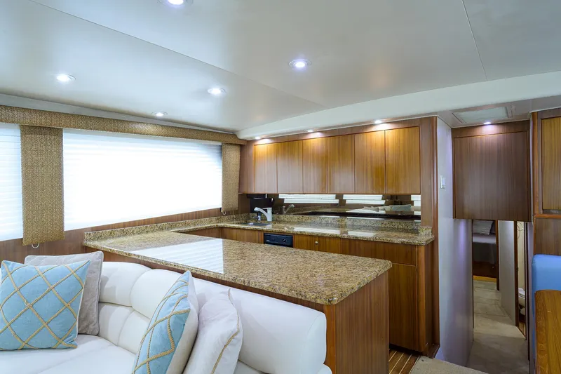  Yacht Photos Pics Luxurious interior of 2005 Viking 61 yacht with modern kitchen and cozy seating area.