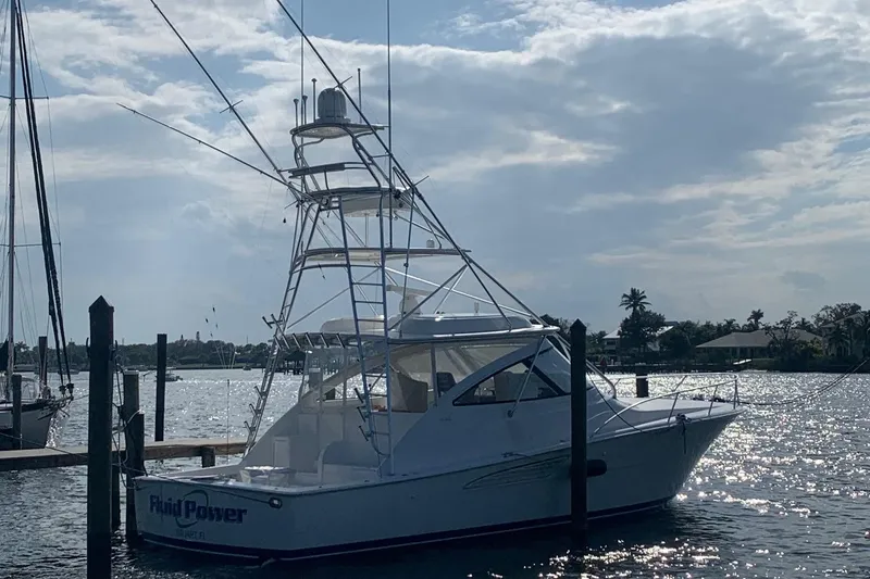 Fluid Power Yacht Photos Pics 2019 Viking 44 Sport Coupe yacht docked on a sunny day.