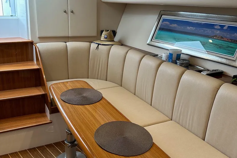 Fluid Power Yacht Photos Pics Luxurious interior of 2019 Viking 44 Sport Coupe with elegant seating and wooden table.