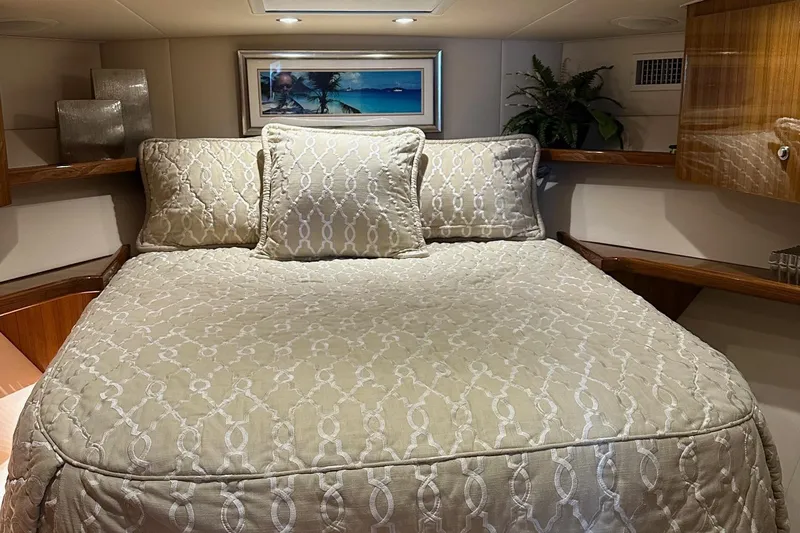 Fluid Power Yacht Photos Pics Luxurious bedroom interior of 2019 Viking 44 Sport Coupe yacht with elegant bedding and decor.