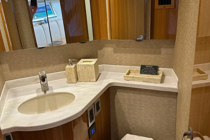 Fluid Power Yacht Photos Pics Luxurious bathroom in 2019 Viking 44 Sport Coupe yacht with modern fixtures and elegant design.