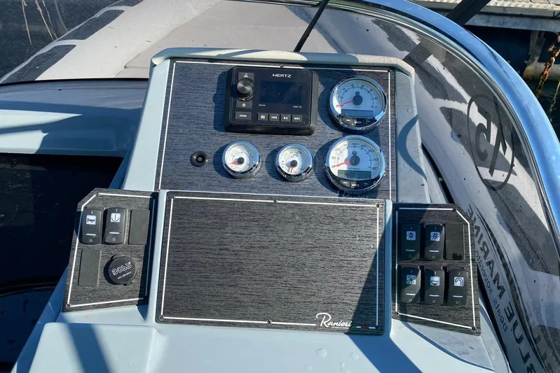  Yacht Photos Pics Control panel of 2022 Ranieri CAYMAN 27.0 SPORT TOURING boat with gauges and switches.