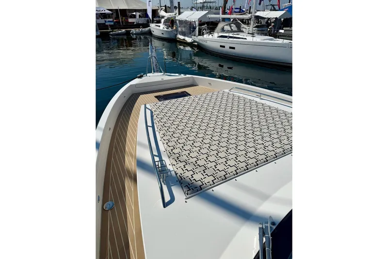  Yacht Photos Pics 2026 Delta Powerboats 48 Coupe yacht with patterned deck, docked at marina.