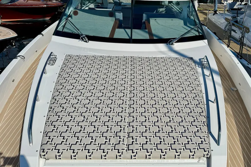  Yacht Photos Pics 2026 Delta Powerboats 48 Coupe with patterned sunbed on deck.