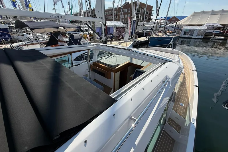  Yacht Photos Pics 2026 Delta Powerboats 48 Coupe at marina, showcasing sleek design and modern features.