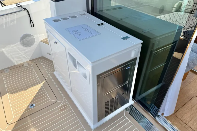  Yacht Photos Pics Modern interior of 2026 Delta Powerboats 48 Coupe, featuring sleek cabinetry and glass door.