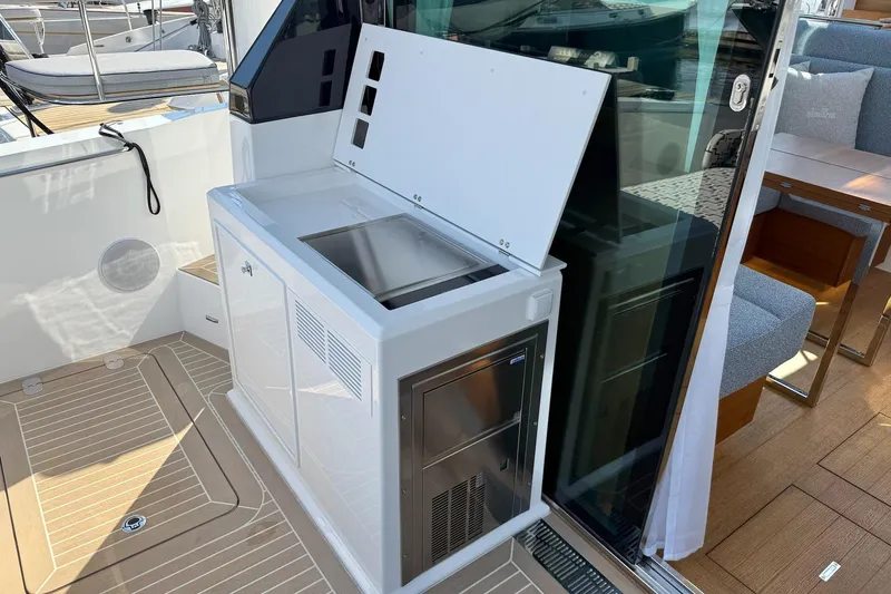  Yacht Photos Pics Outdoor kitchenette on 2026 Delta Powerboats 48 Coupe with sink and storage.