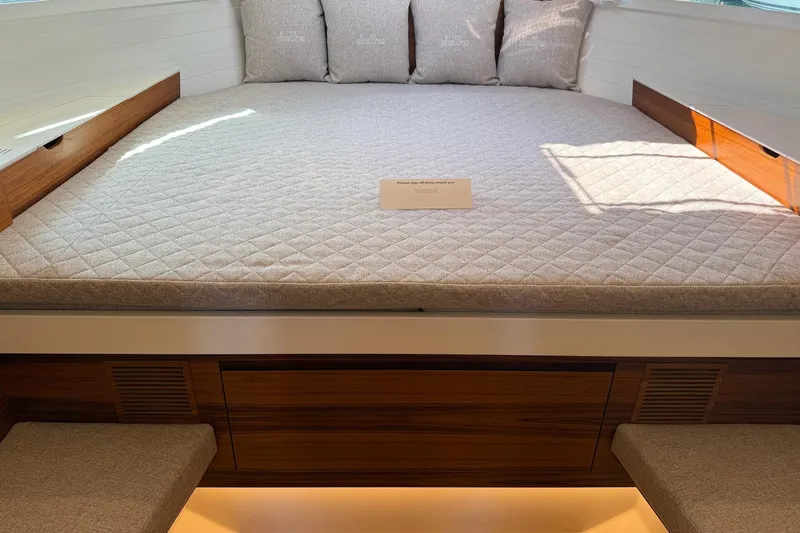  Yacht Photos Pics Luxurious interior of 2026 Delta Powerboats 48 Coupe with elegant bedding and wooden accents.