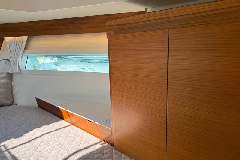  Yacht Photos Pics Luxurious interior of 2026 Delta Powerboats 48 Coupe with wood paneling and window view.